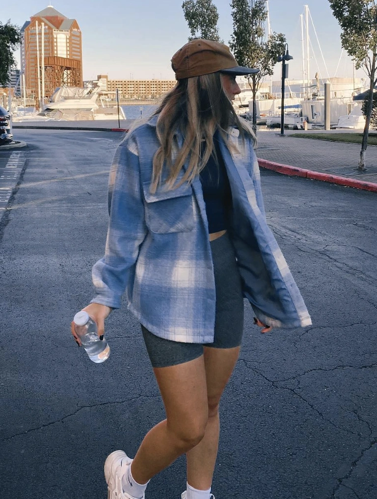 Oversized blue plaid shirt, black crop top, and gray biker shorts; perfect for casual outings or warm weather activities.