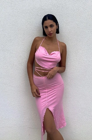 Pink halter crop top and pencil skirt set; fitted style with a slit, perfect for summer parties or casual outings.