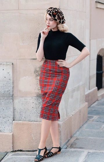 Fitted plaid pencil skirt in red and black, paired with a black ribbed top; perfect for casual or semi-formal occasions.