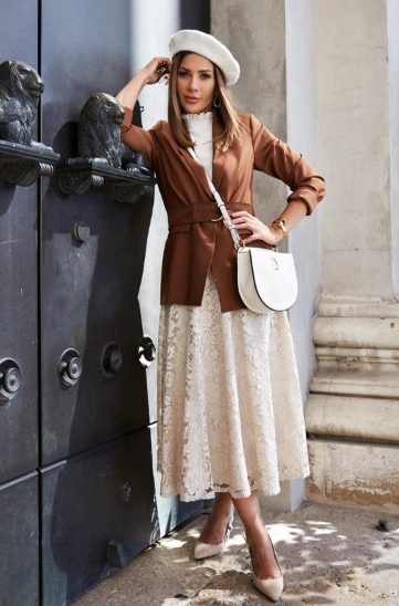 A long beige lace skirt paired with a fitted brown blazer, perfect for formal or semi-formal occasions.