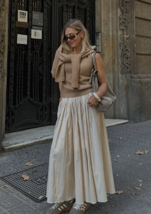 A casual beige maxi skirt paired with a knitted sleeveless top, featuring a gathered waist, perfect for everyday outings.