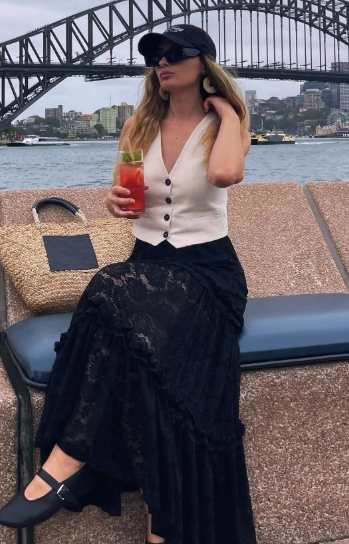 Black lace maxi skirt paired with a fitted white vest; perfect for casual outings or summer events.