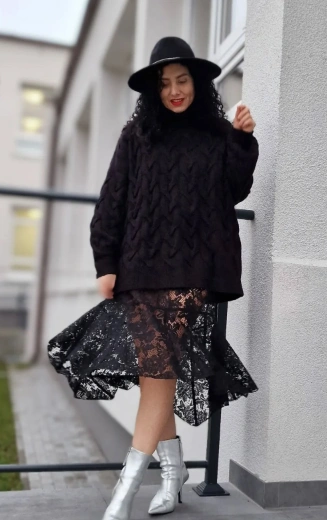 Black lace midi skirt paired with a chunky knit sweater, featuring a high-low hem, suitable for casual outings or gatherings.