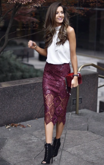 Lace midi skirt in burgundy paired with a sleeveless white top, ideal for formal occasions or date nights.