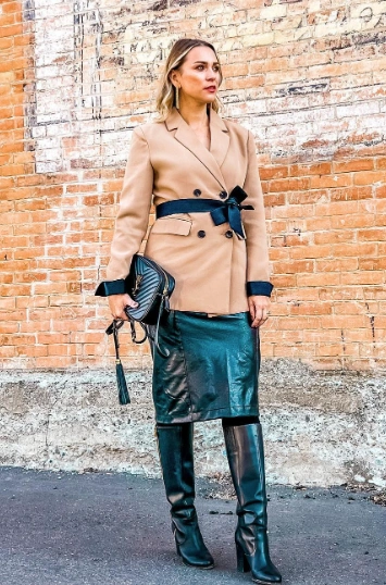 A stylish camel double-breasted blazer paired with a sleek black pencil skirt, perfect for formal occasions.