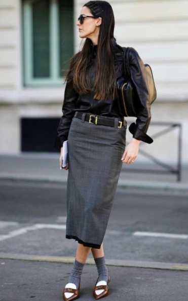 Gray pencil skirt paired with a black leather top, featuring a belted waist and stylish accessories. Ideal for formal occasions.