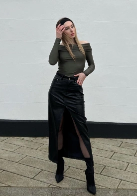 Off-shoulder olive top paired with a black, high-slit long skirt, perfect for casual or semi-formal occasions.