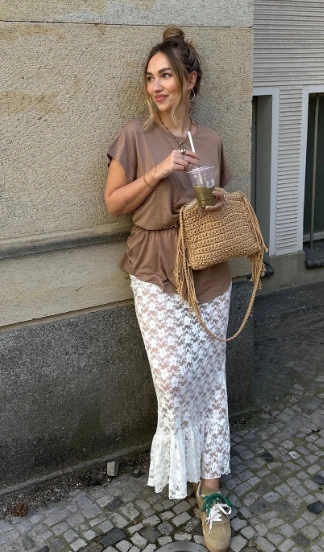 A casual outfit featuring a brown top and a white lace skirt, perfect for warm weather outings or brunch.