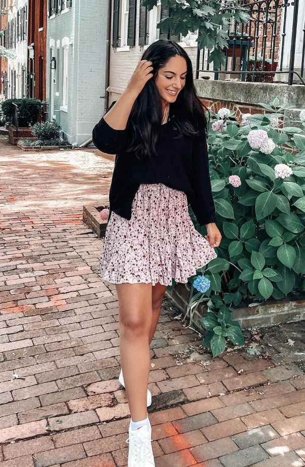 A casual floral mini skirt in soft pink with a ruffled hem, perfect for summer outings or brunch.