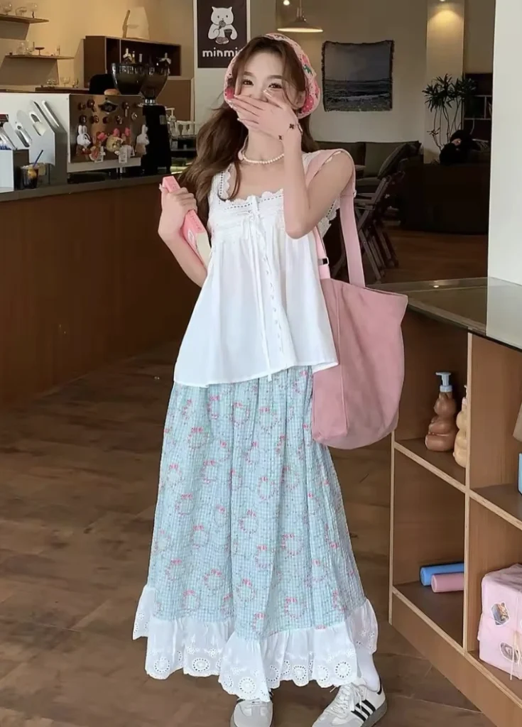 Casual floral maxi skirt in mint green with pink roses, paired with a white sleeveless top; perfect for spring outings or brunch.