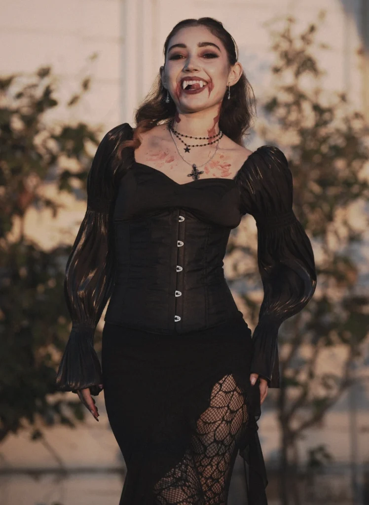 Black corset-style dress with puffed sleeves, featuring lace accents and a high slit; perfect for Halloween or themed parties.