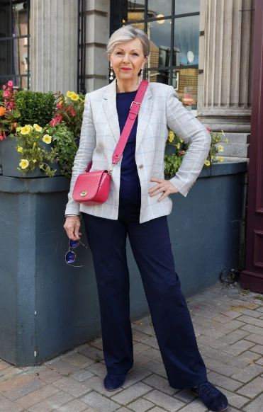 Tailored plaid blazer over a navy top, paired with navy trousers. Chic and sophisticated, perfect for business or casual outings.