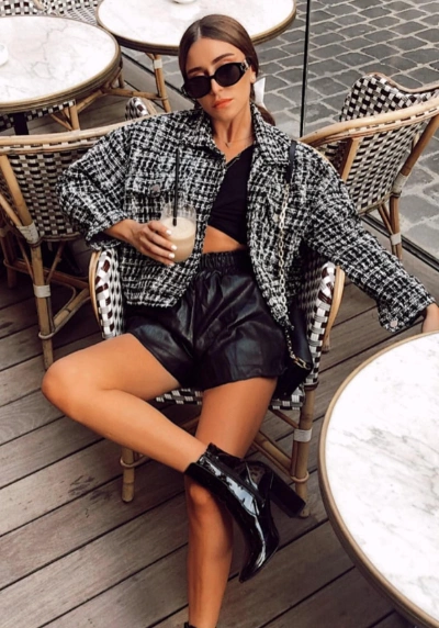Oversized tweed jacket, black crop top, and high-waisted leather shorts; stylish and casual, perfect for brunch or outings.