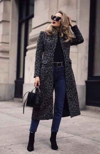 Long leopard print coat over a black top, paired with high-waisted jeans; suitable for stylish casual work occasions.