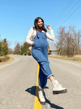 Denim overalls with a relaxed fit, featuring long sleeves and a scoop neckline, perfect for casual outings.