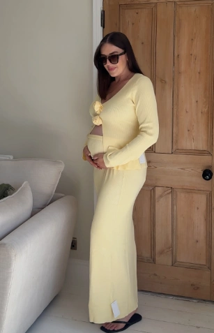 Cozy yellow maternity outfit featuring a ribbed long-sleeve top and matching skirt, perfect for casual outings.