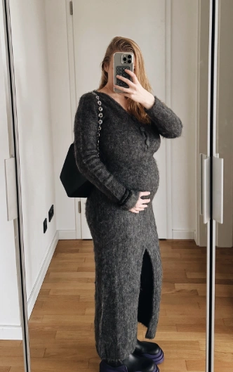 Long-sleeve, grey knit maxi dress with a deep V-neckline and side slit, perfect for casual outings or gatherings.