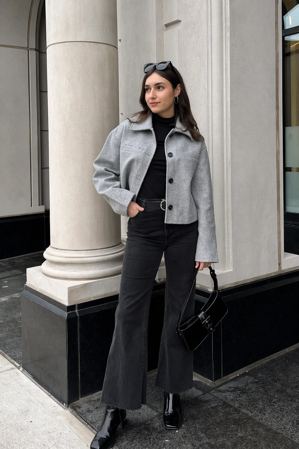 Casual outfit featuring grey flare jeans, a matching cropped jacket, and a black turtleneck, perfect for everyday wear.