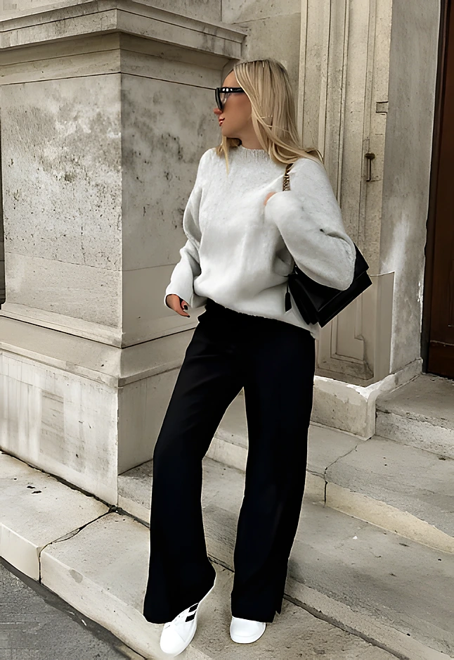 Cozy grey knit sweater paired with black wide-leg trousers, perfect for casual outings or relaxed gatherings.