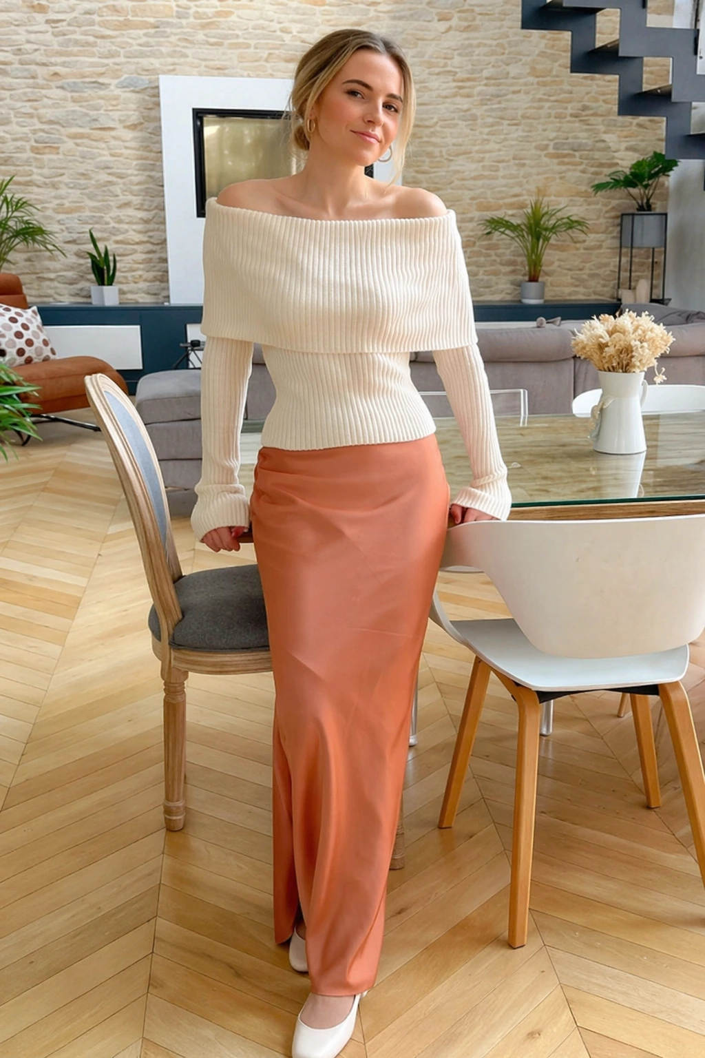 Off-shoulder knit top in cream paired with a rust satin pencil skirt, ideal for formal events or stylish outings.