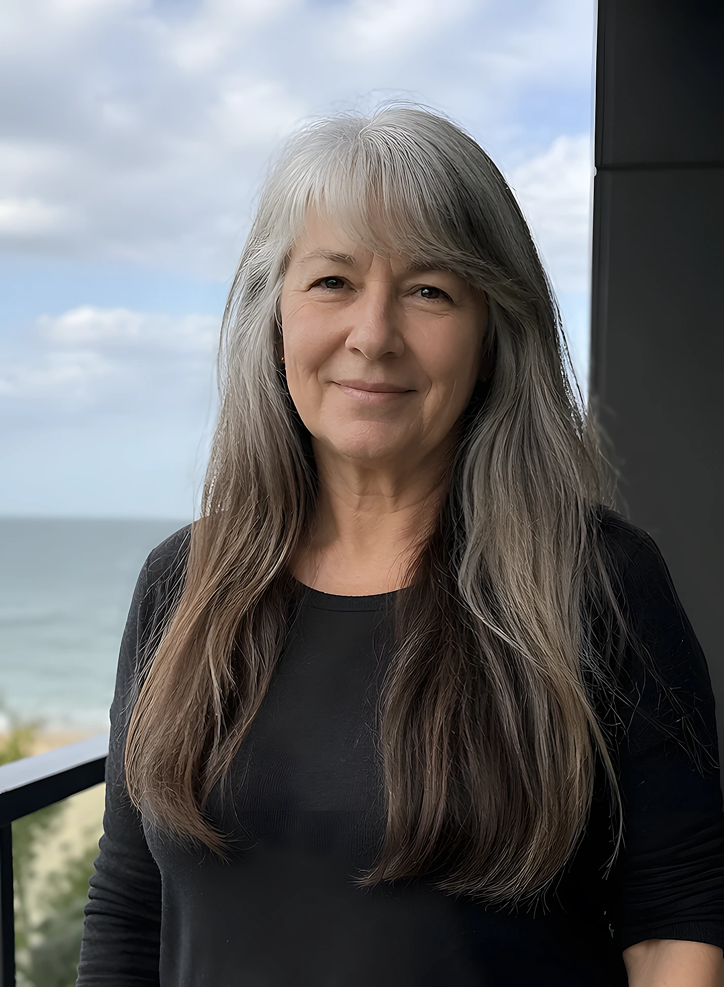 Long straight gray hair with a center part, smooth texture, subtle face-framing layers, and natural shine.