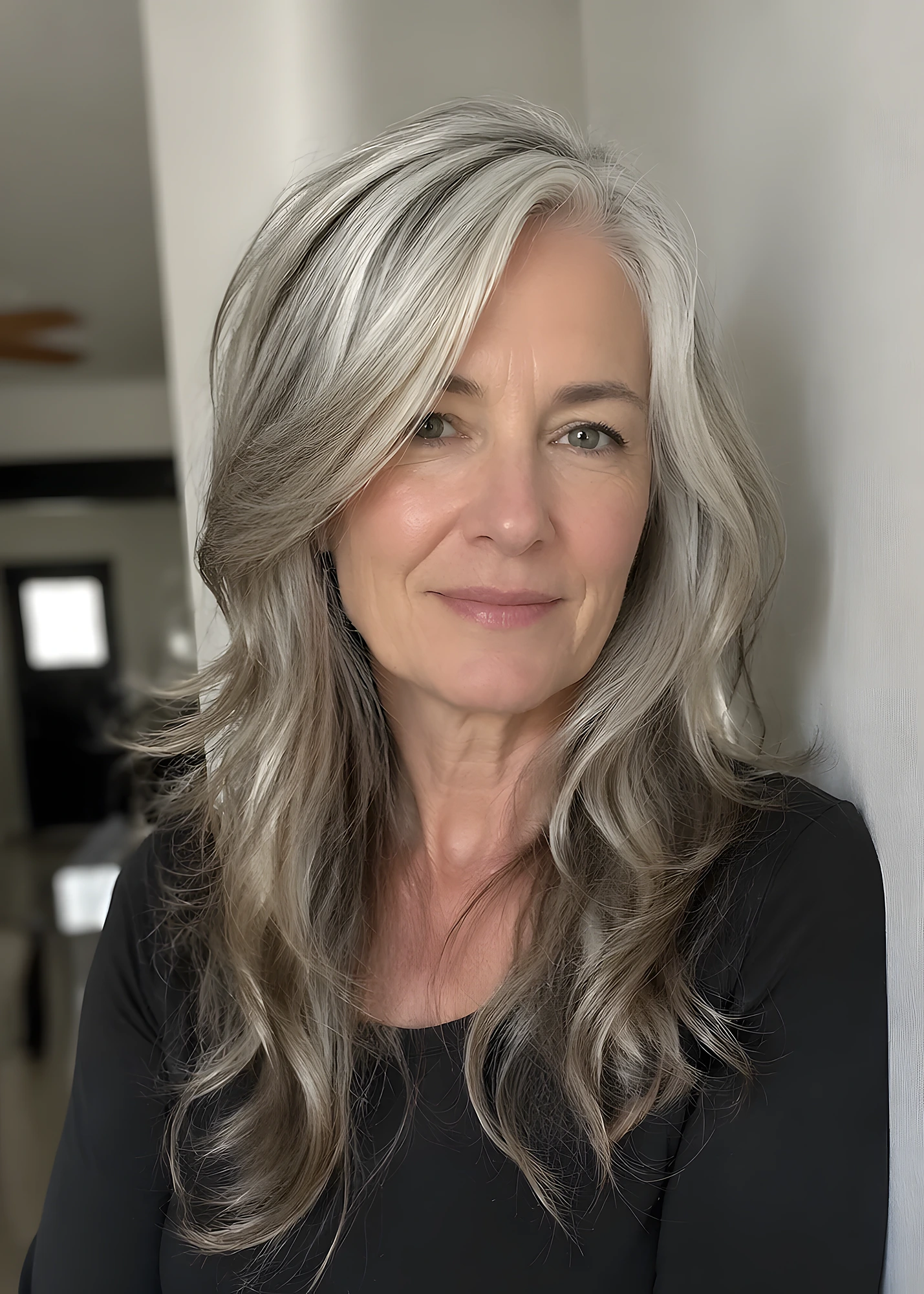 Woman with medium-long silver hair, feathered layers, soft volume, and a deep side-swept fringe.