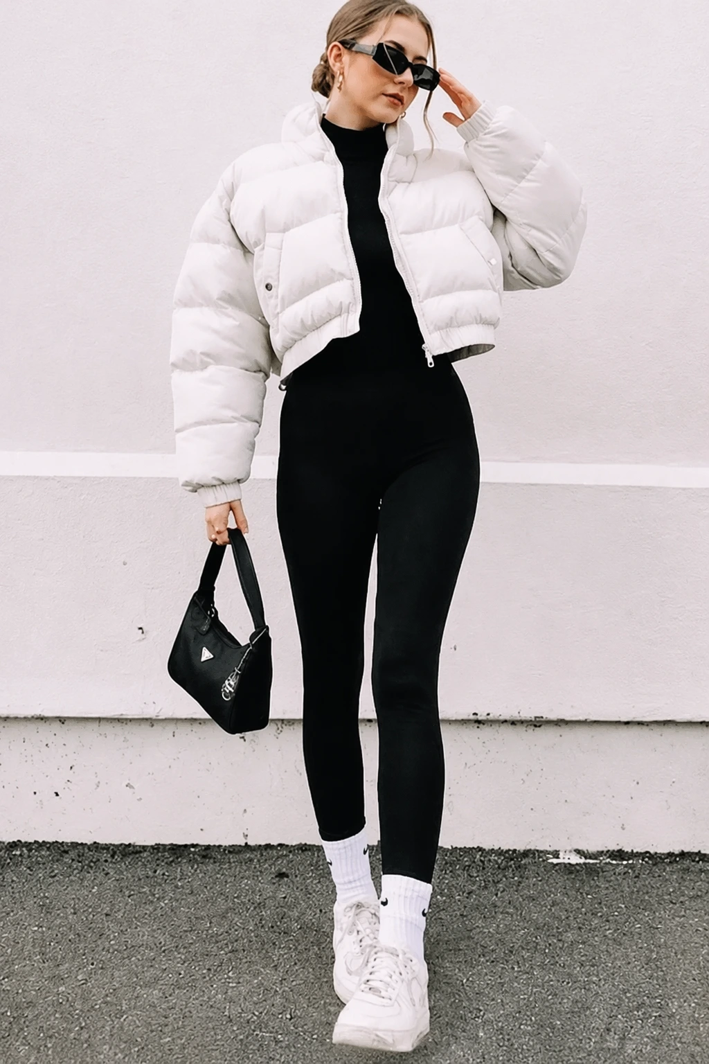 White puffer jacket with black turtleneck and black leggings
