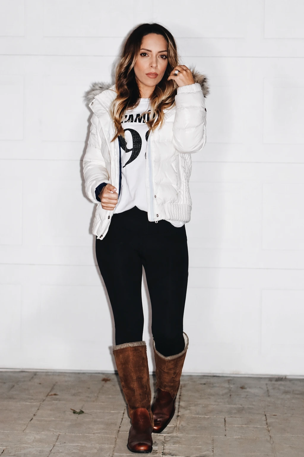 White puffer jacket with graphic sweatshirt and black leggings