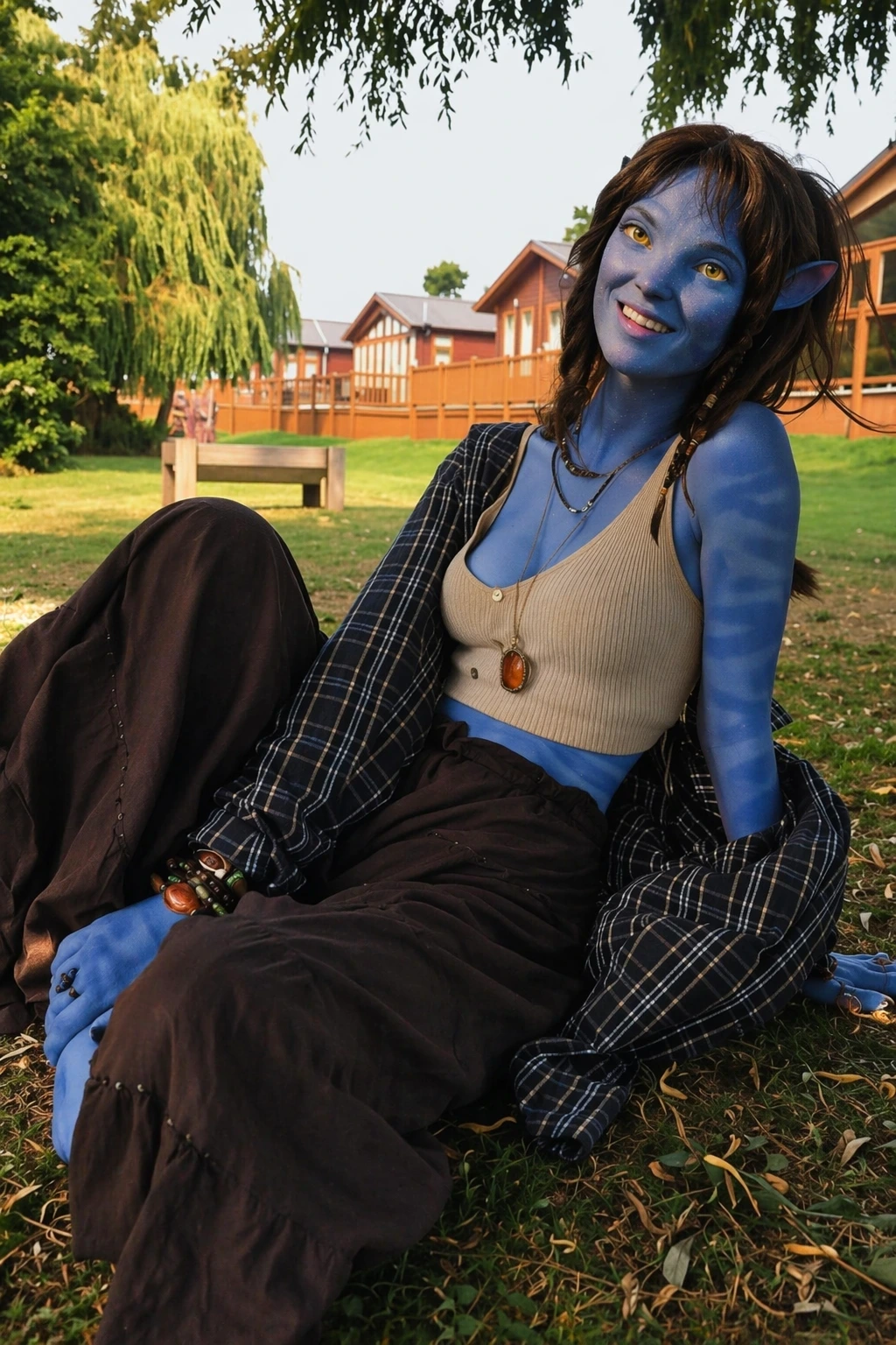 Blue-skinned avatar-style woman sits outdoors on grass, wearing plaid layers, dark trousers, and layered necklaces.