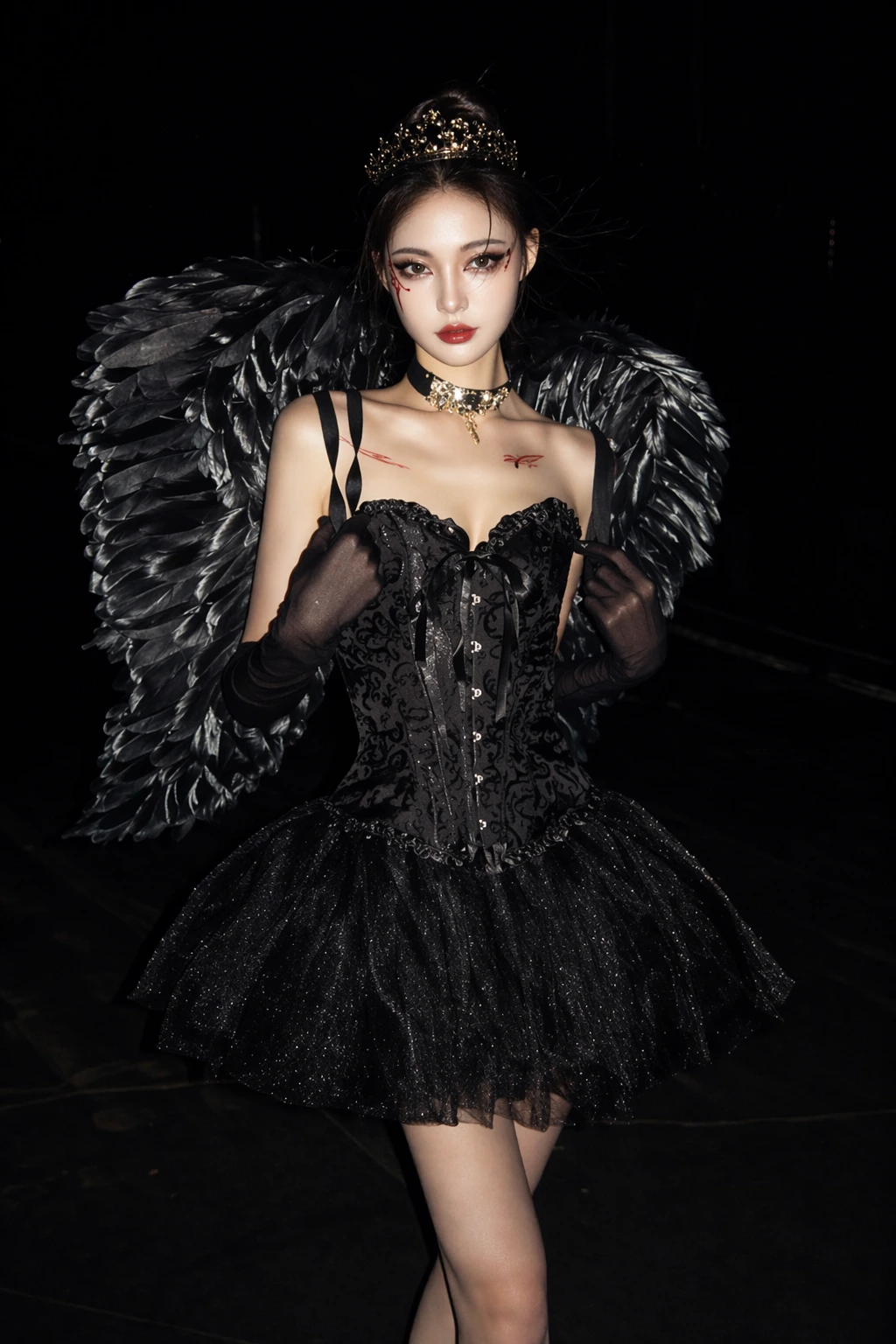 Dramatic dark fairy costume featuring large black feather wings, jeweled crown, corset top, and sparkly tulle skirt.
