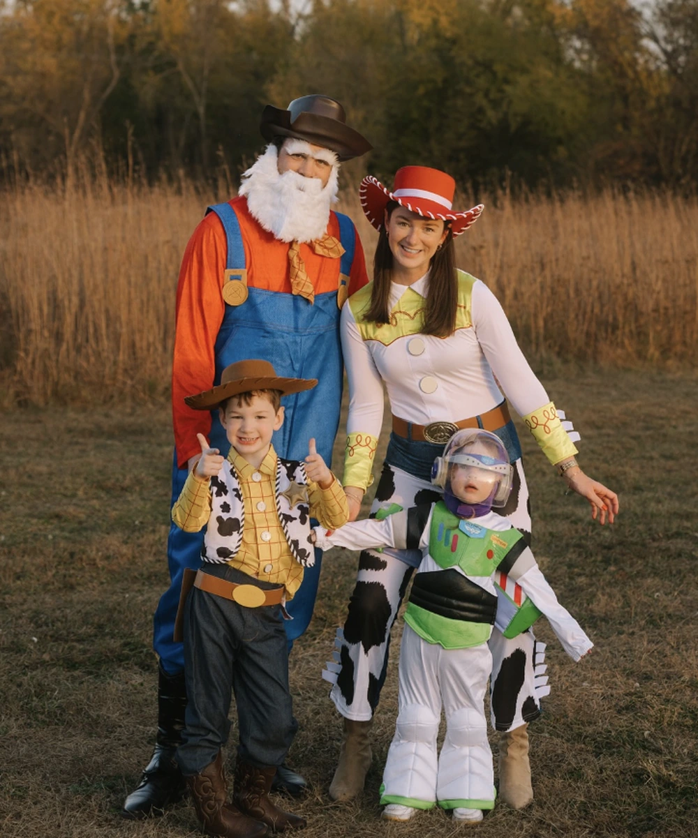 Family outdoors dressed as Toy Story characters, including Woody, Jessie, Buzz Lightyear, and Bo Peep.